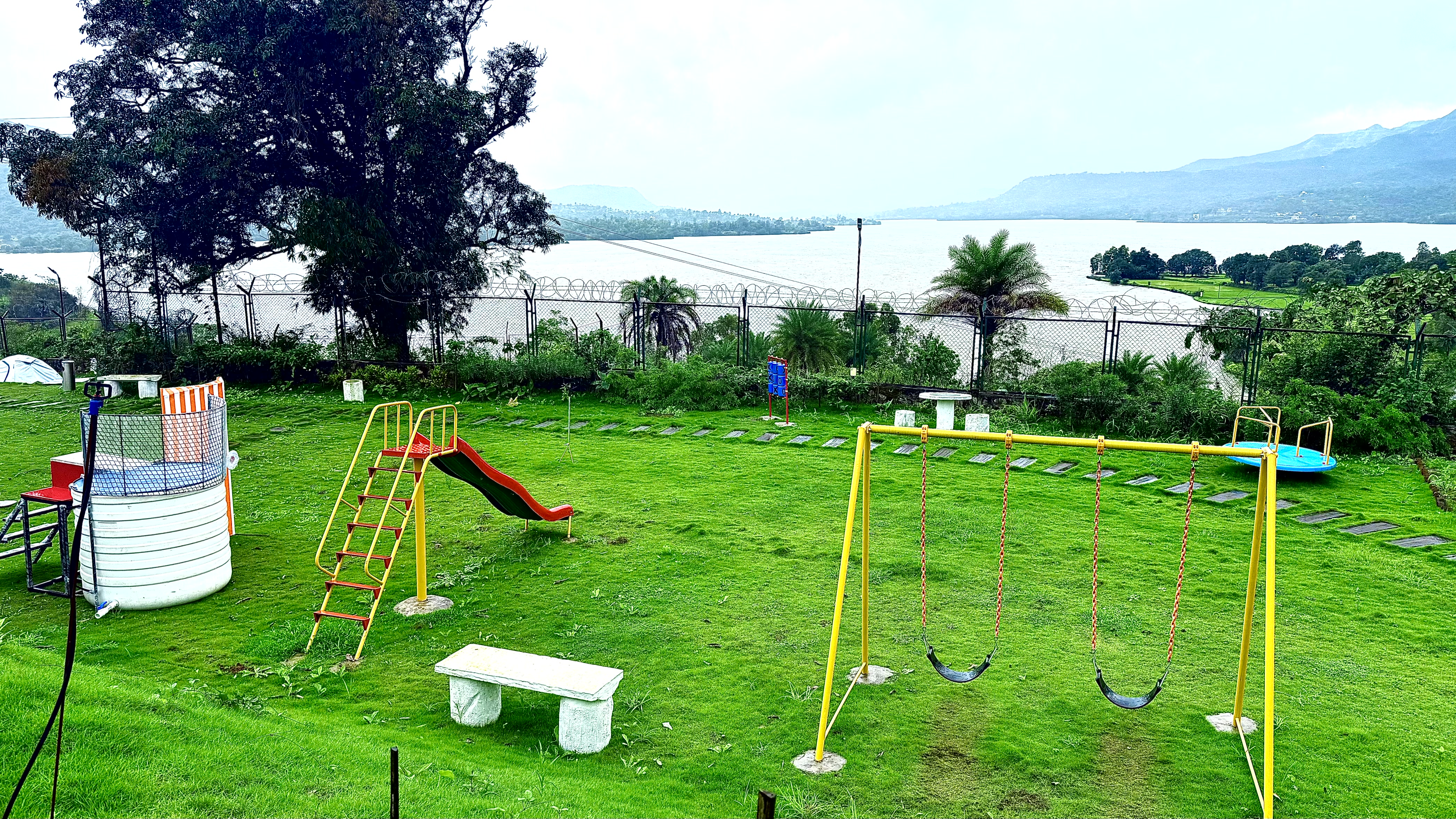 Kids play zone with slide and swings at Lemon Leaf Resort